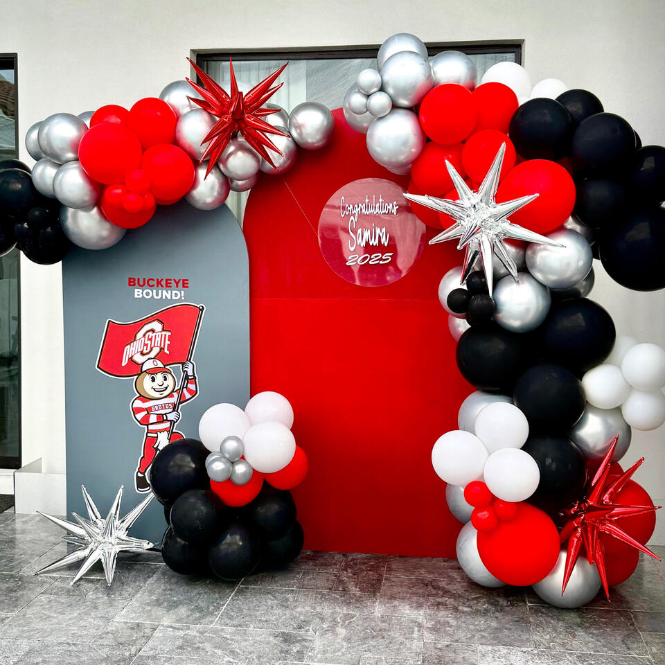 Ohio State Grad Party college-inspired grad party set up with arches, organic balloon garland, and custom graphics