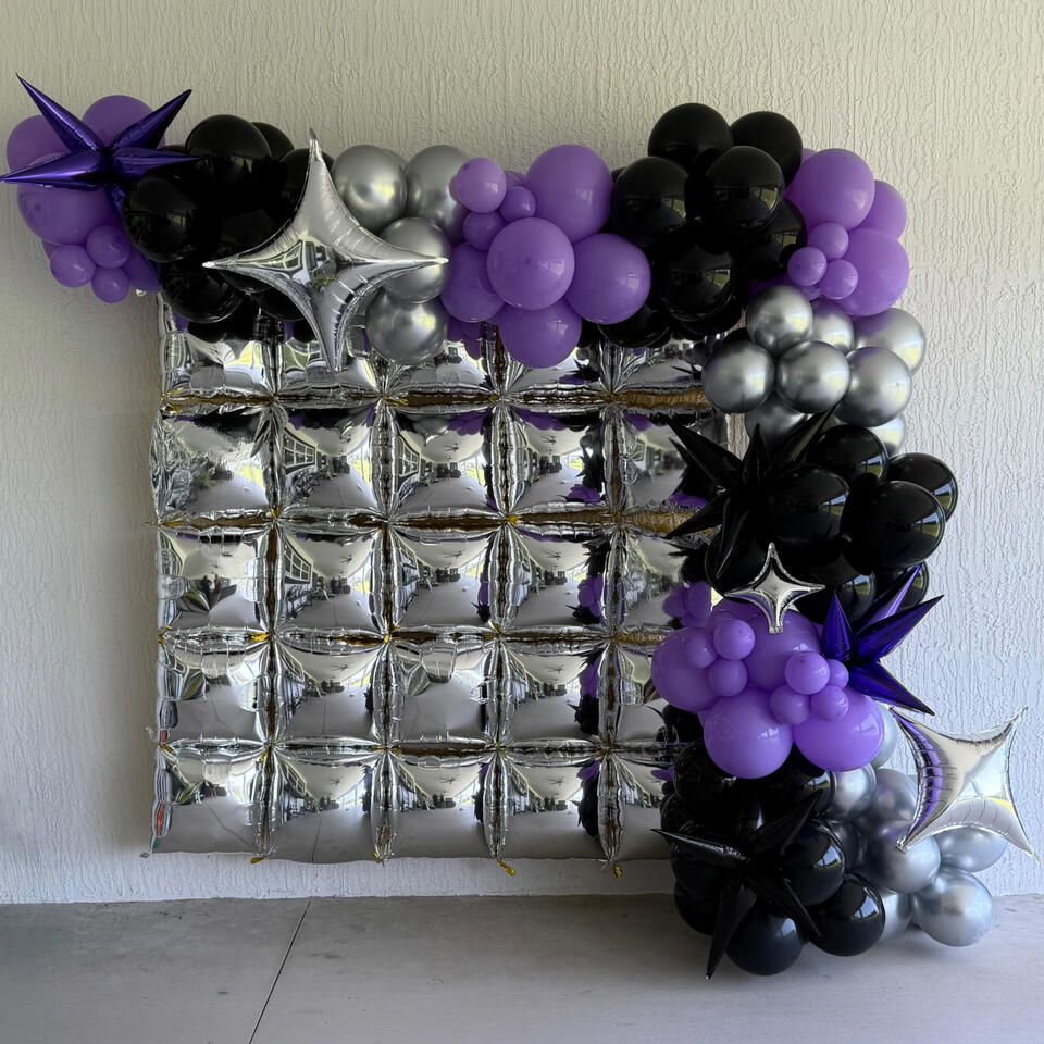 Foil Wall Feature silver foil wall feature with an organic garland in purple, black, and silver