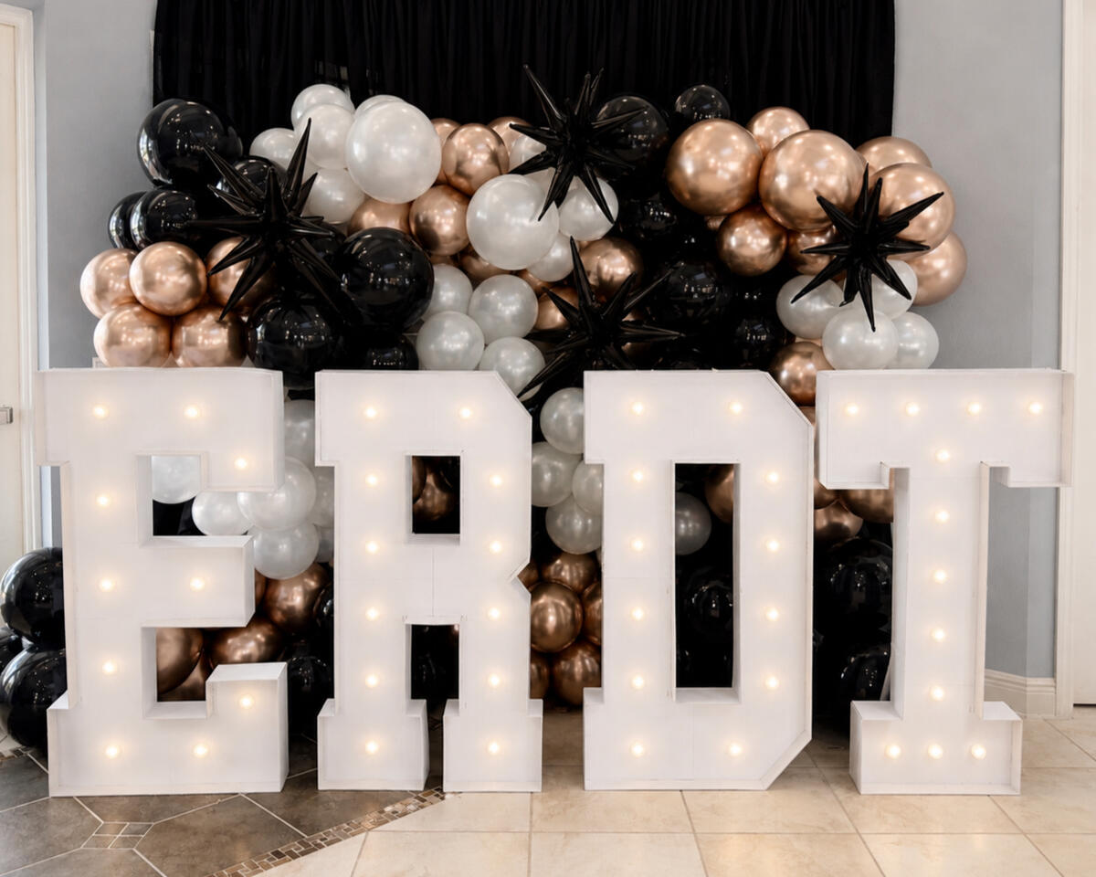 Recognition Banquet versized marquee letters paired with an organic balloon installation to create a statement photo opportunity for graduation celebrations and team banquets.